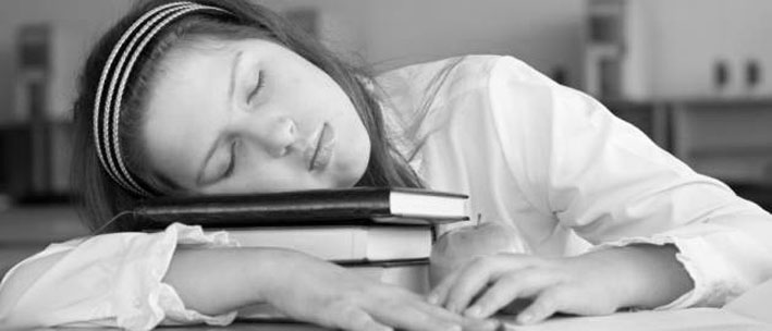Schoolgirl is sleeping with her books at lesson