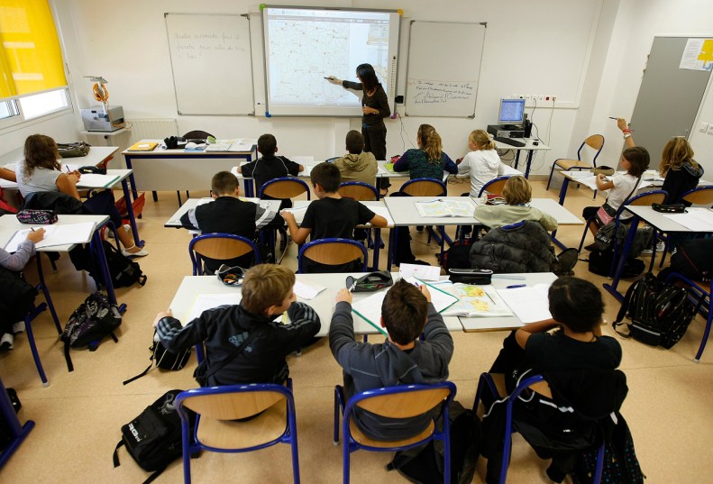 French junior high students follow a geography lesson taught with a digital touch blackboard at the Rene Cassin school in Tourette Levens, near Nice